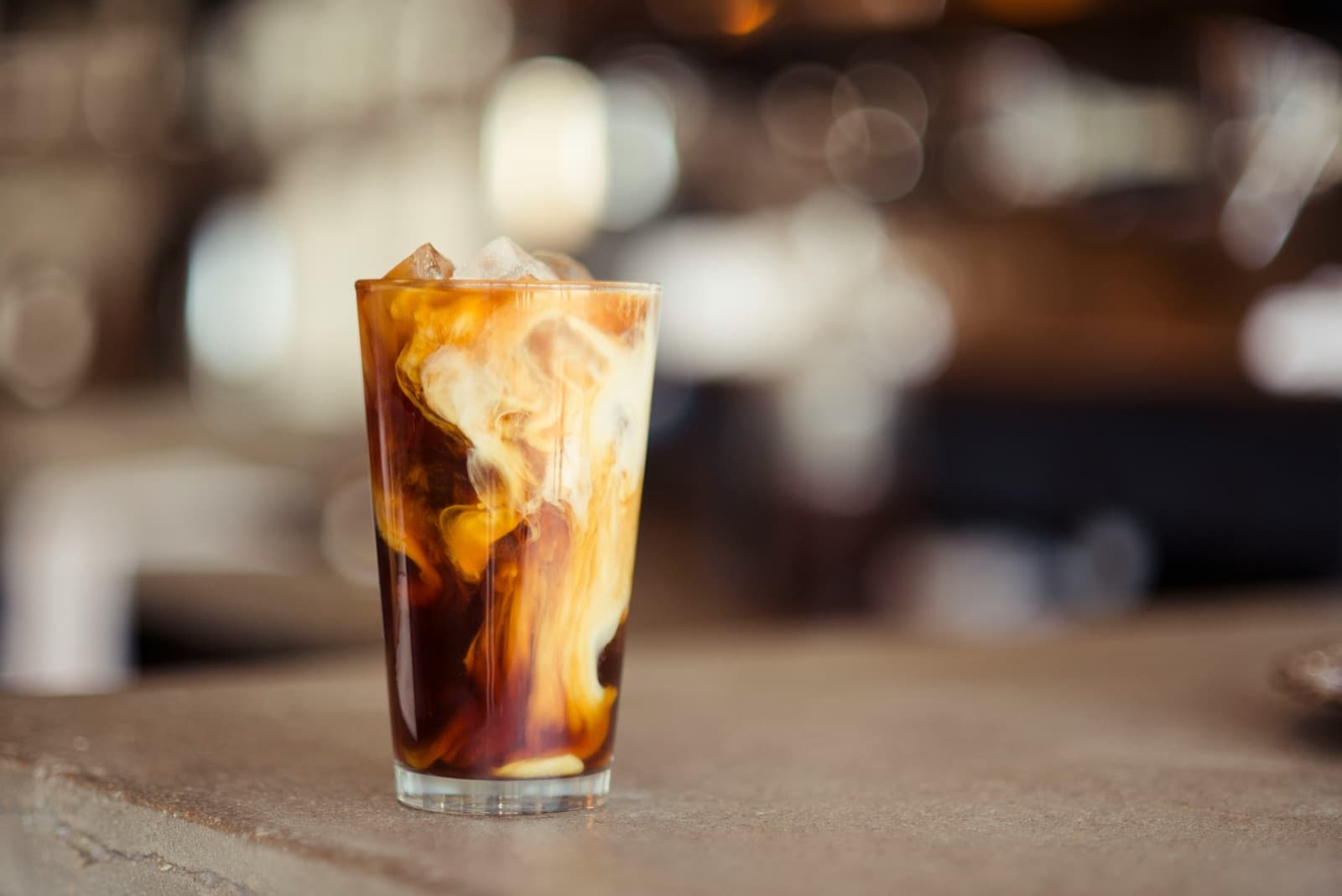 Iced Thai coffee on a cafe table